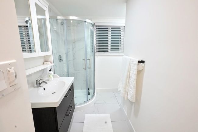 Full bath with vanity, marble finish floors, and a marble finish shower | Image 32