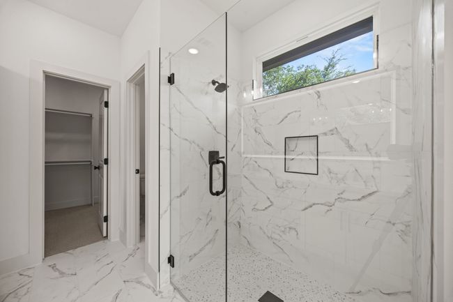Full bath featuring a marble finish shower and a spacious closet | Image 19