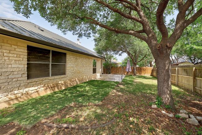 View of yard featuring a fenced backyard and a patio area | Image 28