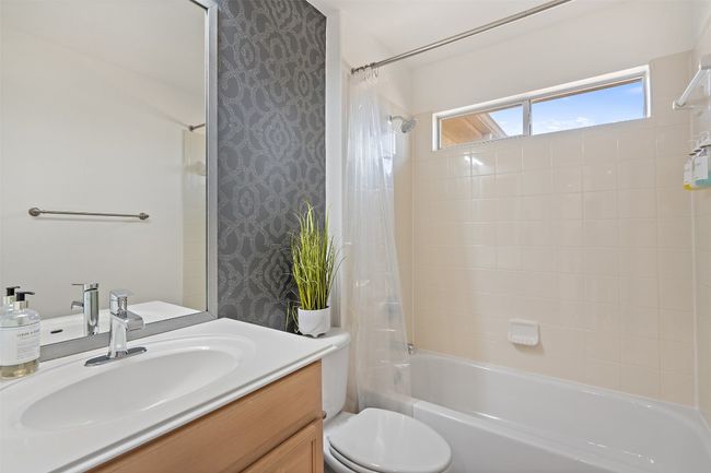 Bathroom with shower / bath combination with curtain, toilet, and vanity | Image 19