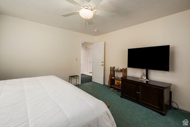 Bedroom featuring carpet floors, a ceiling fan, and baseboards | Image 24