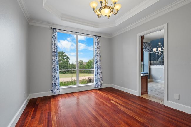 Elegant formal dining space that can be reimagined as a cozy family room, creative music room, or versatile flex area. | Image 12
