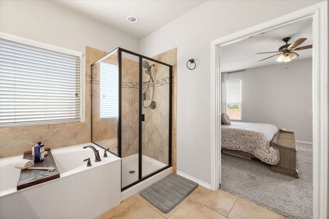 Bathroom featuring a stall shower, a garden tub, ensuite bathroom, and tile patterned floors | Image 26