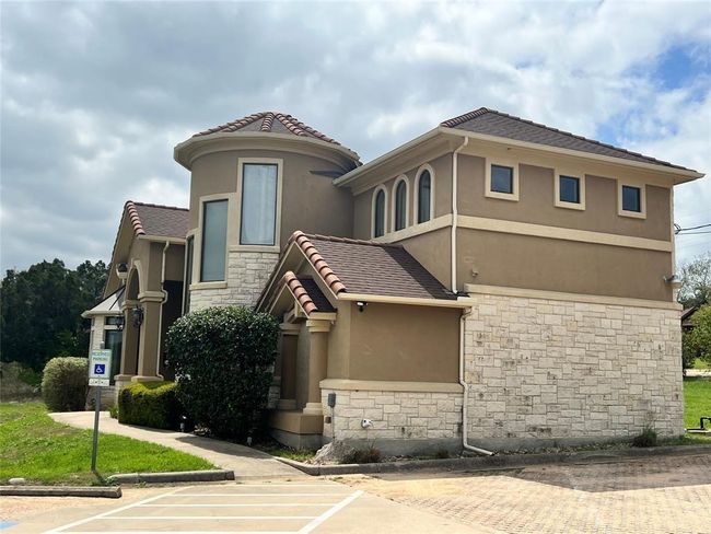 View of front of property with stone siding, a tiled roof, and stucco siding | Image 22