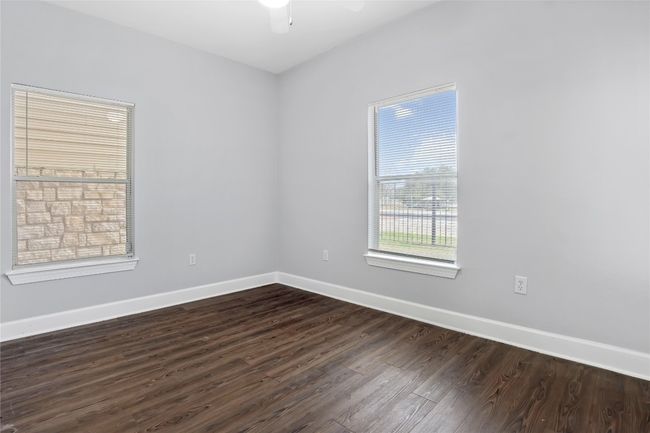Spare room featuring dark wood finished floors, a ceiling fan, and baseboards | Image 18