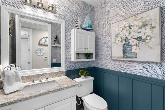 Half bath with a wainscoted wall, vanity, and a decorative wall | Image 24
