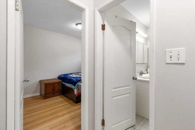 Bathroom with vanity, wood finished floors, and a textured ceiling | Image 19