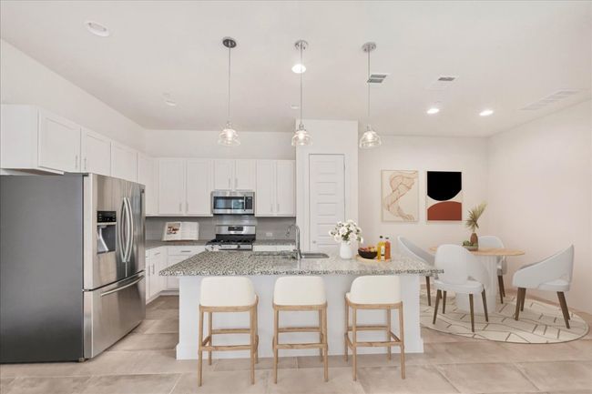 The eat-in kitchen is open to the living room and features a huge island. Virtually staged. | Image 4