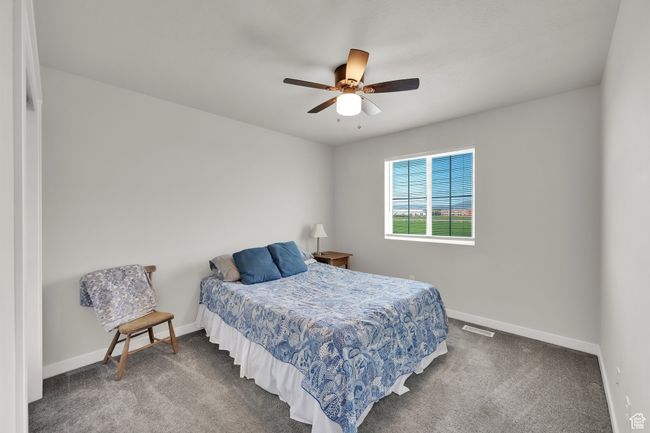 Bedroom with carpet floors and ceiling fan | Image 22