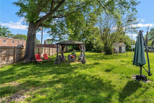 View of yard with a fenced backyard and a gazebo | Image 34