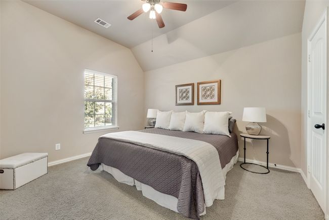 Bedroom featuring carpet flooring, ceiling fan, and lofted ceiling | Image 20