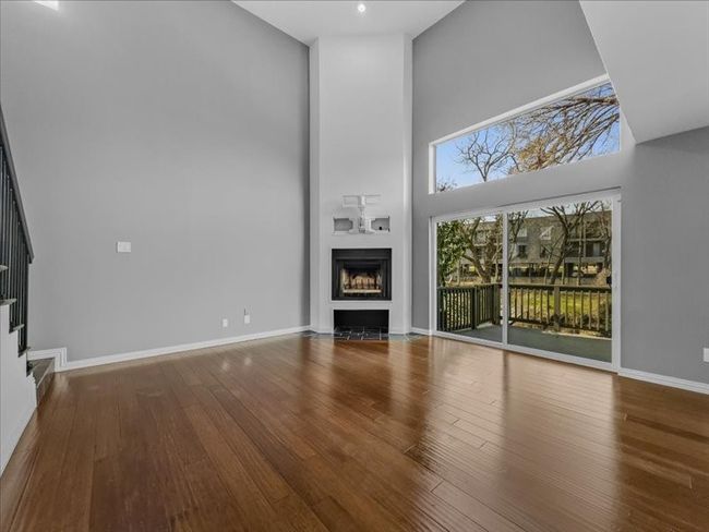 Living room featuring hardwood / wood-style flooring and a high ceiling | Image 6