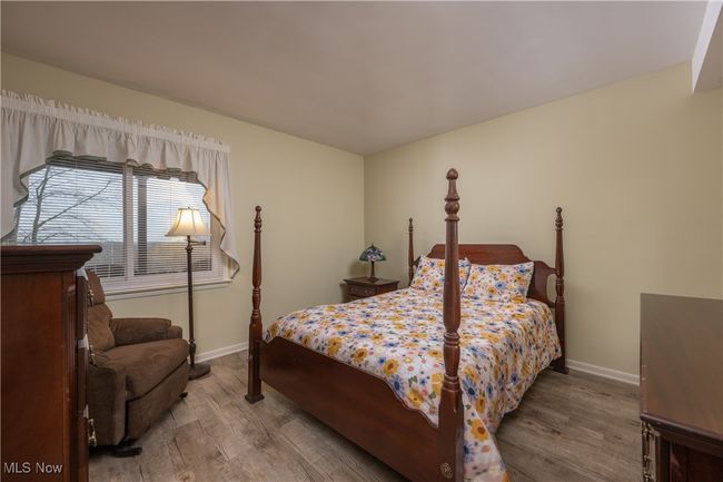 Bedroom featuring baseboards and wood finished floors | Image 32