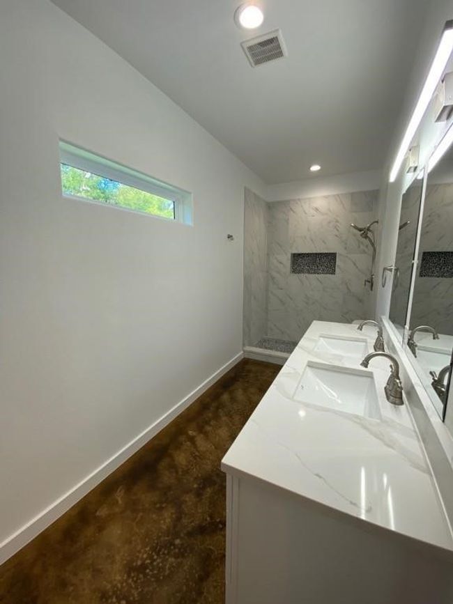 Bathroom featuring double vanity, tiled shower, baseboards, and recessed lighting | Image 20