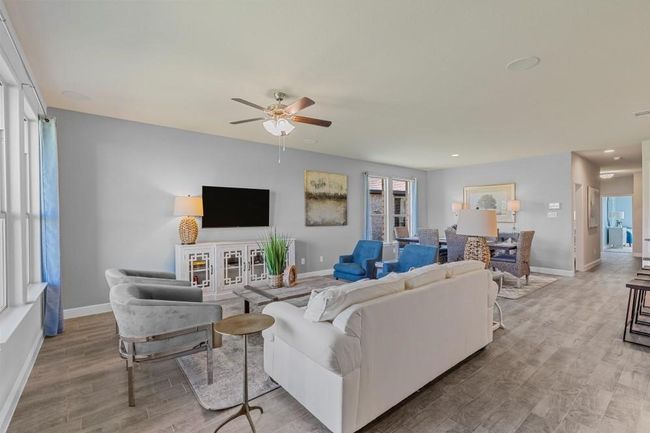 Living area featuring wood finished floors, ceiling fan, and recessed lighting | Image 11