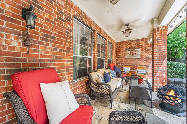 Unwind in this charming covered patio that is perfect for relaxing or entertaining. | Image 27