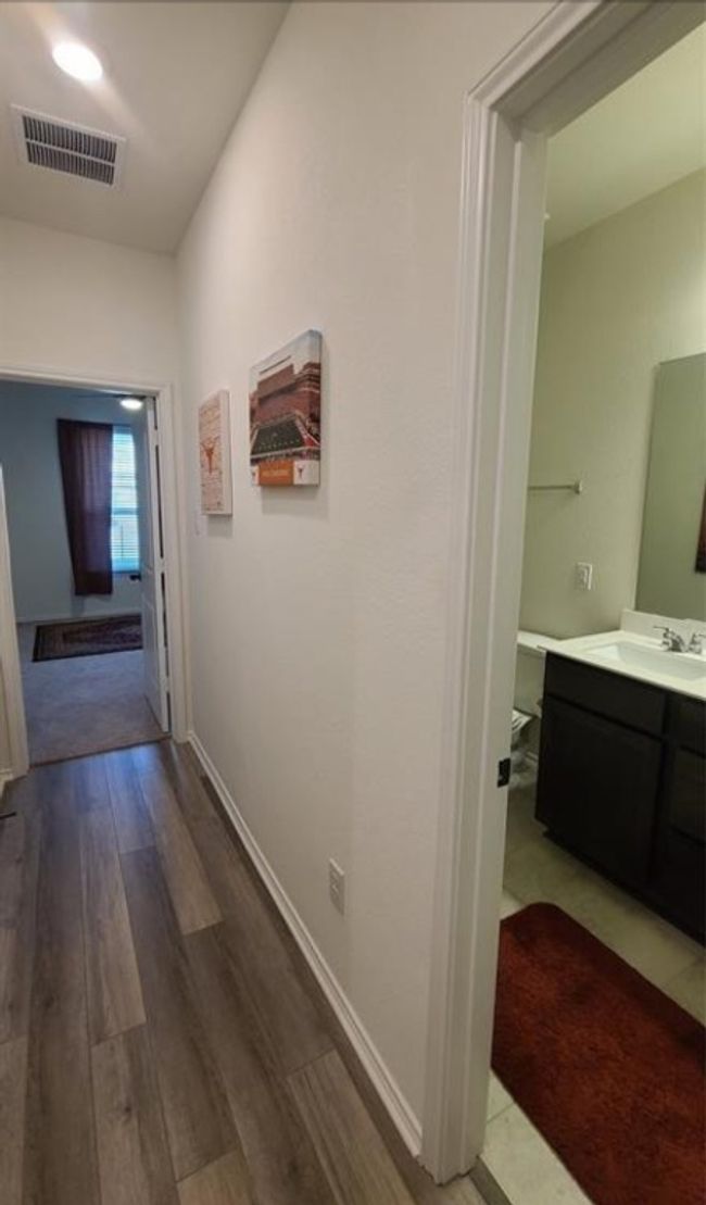 Hall featuring wood finished floors and a sink | Image 7