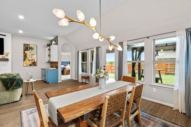 Dining area with baseboards, plenty of natural light, lofted ceiling, recessed lighting, and wood finished floors | Image 9