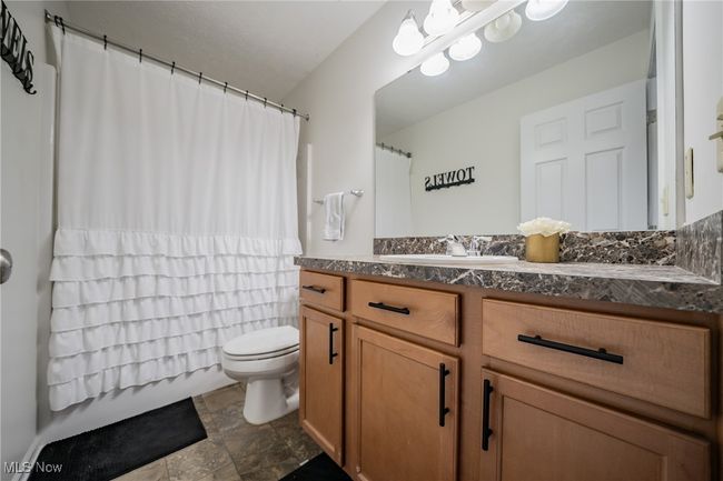 Bathroom featuring vanity, tile patterned flooring, and toilet | Image 13