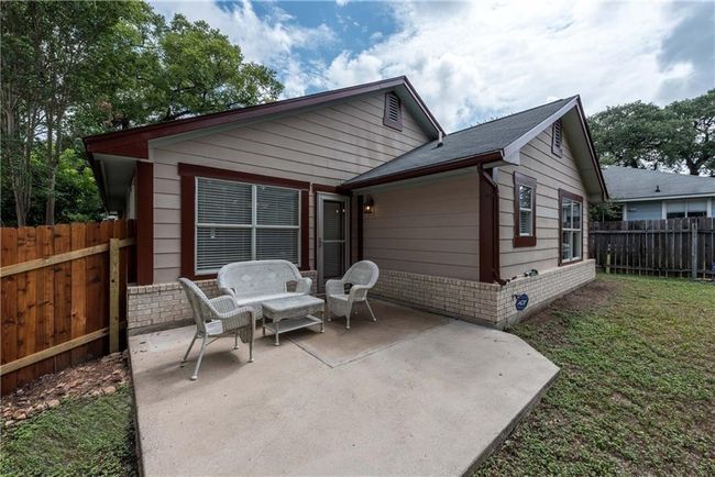 Rear view of house featuring a patio, brick siding, and a fenced backyard | Image 21