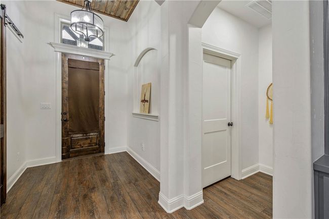Entryway with wood-type flooring, arched walkways, and baseboards | Image 4