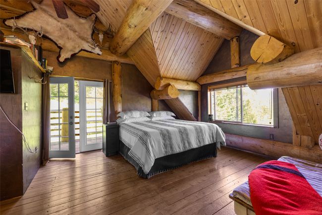 Bedroom featuring wood-type flooring, access to outside, and wood ceiling | Image 20
