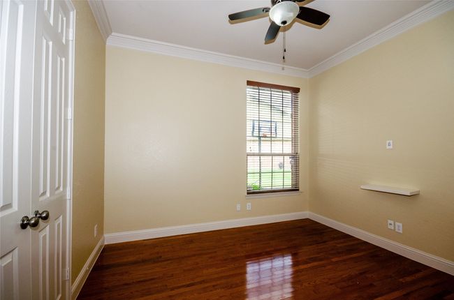 Unfurnished room with ornamental molding, baseboards, ceiling fan, and dark wood-type flooring | Image 13