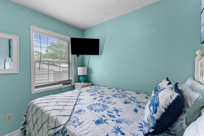 Bedroom featuring a textured ceiling and baseboards | Image 19