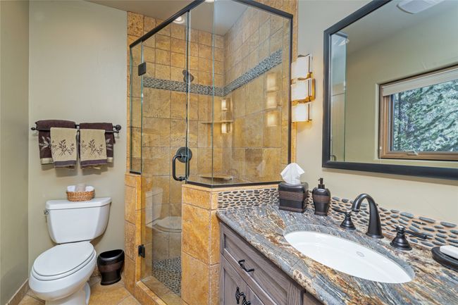 Bathroom featuring toilet, tile patterned floors, walk in shower, and vanity | Image 29
