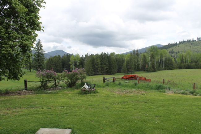 View of green lawn featuring a mountain view and a rural view | Image 8