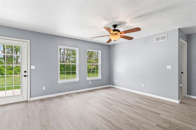 Empty room featuring baseboards, visible vents, a ceiling fan, and light wood finished floors | Image 5