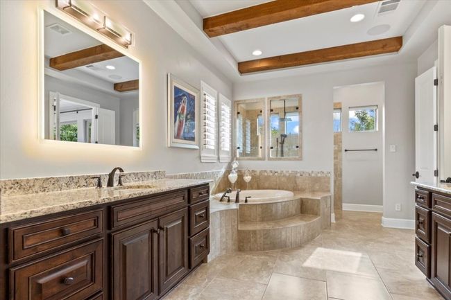 Full bathroom with a bath, beamed ceiling, vanity, and visible vents | Image 19