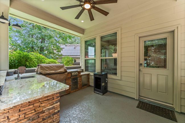 Outside covered back patio with built in kitchen. | Image 23