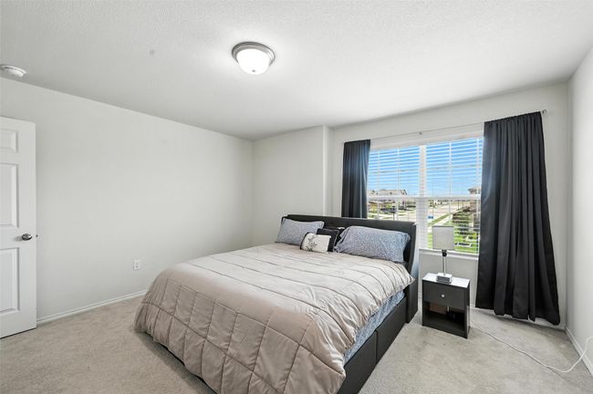Bedroom featuring light colored carpet | Image 34