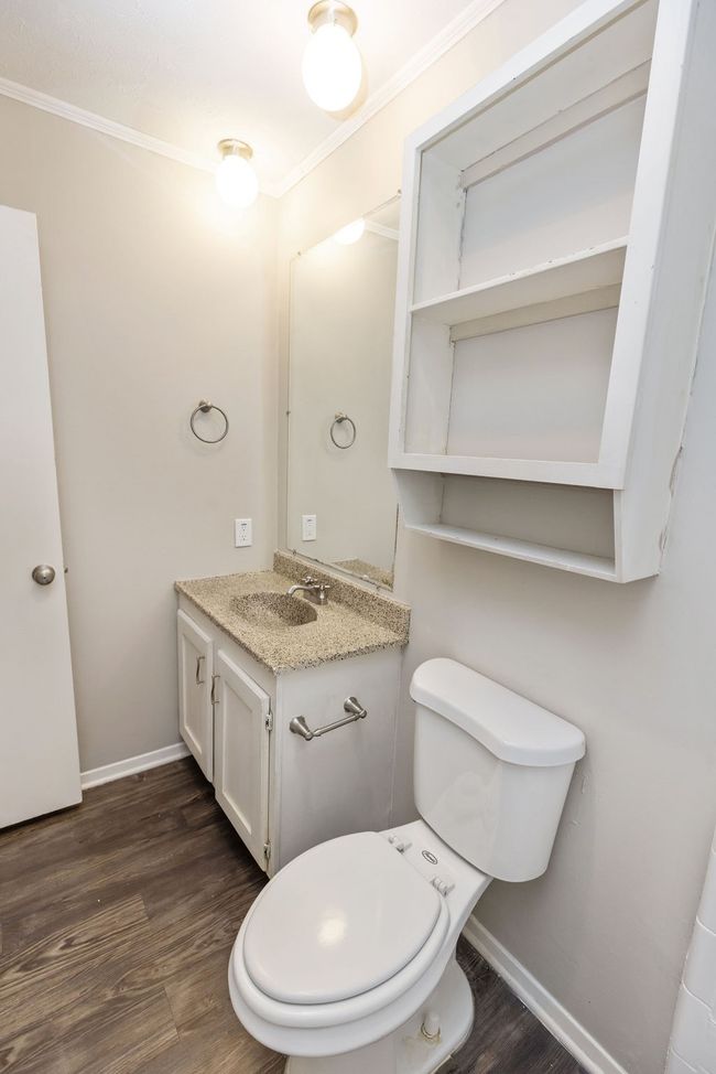 Bathroom with baseboards, wood finished floors, and ornamental molding | Image 18