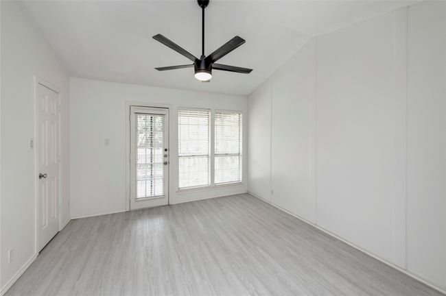 Primary bedroom features balcony, ceiling fan, ensuite bath, & walk in closet | Image 6