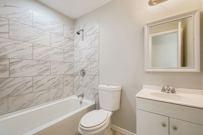 Bathroom with vanity and washtub / shower combination | Image 10