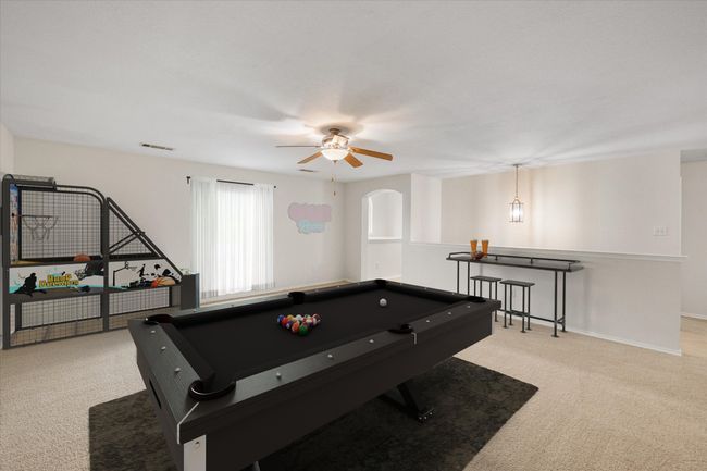 Game room with light carpet, pool table, ceiling fan, and arched walkways | Image 20