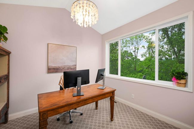 Enjoy stunning views while you work in this main-floor office! This room has a closet and could be used as a bedroom. | Image 23