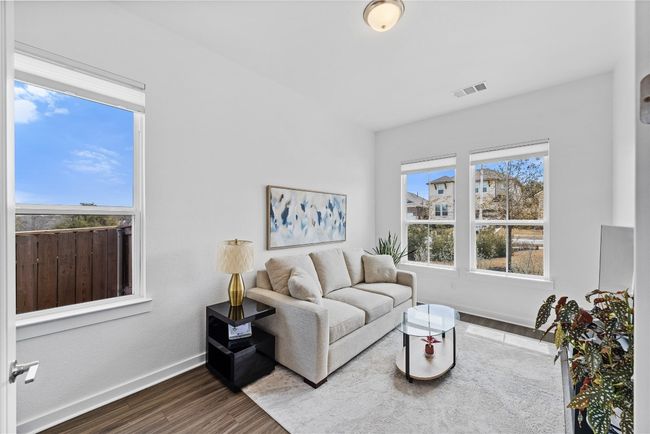 Living area with baseboards, dark wood-style floors, and visible vents | Image 12