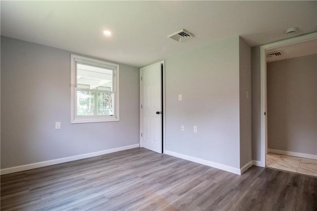 Unfurnished bedroom featuring hardwood / wood-style floors | Image 12