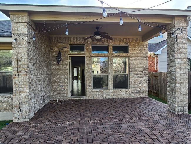 Entrance to property featuring a ceiling fan and brick siding | Image 34