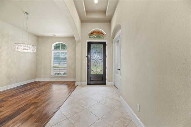 Looking towards the front door, the formal dining room is on your left. To the right, behind French doors, is the home office/study. | Image 6