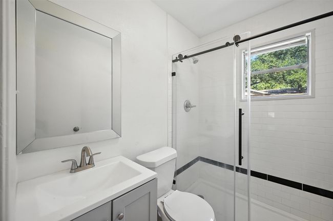 Full bathroom featuring a shower stall and vanity | Image 14