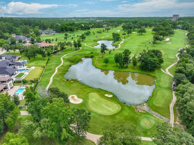 Aerial view of a large body of water, a local golf course, and a tree filled landscape | Image 10