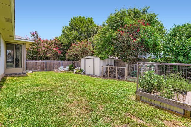 Fenced backyard with a garden and a shed | Image 25