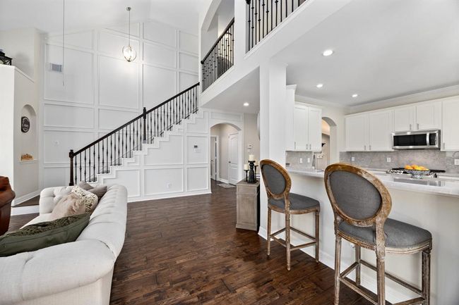 The kitchen seamlessly flows into the living room via the bar. | Image 10