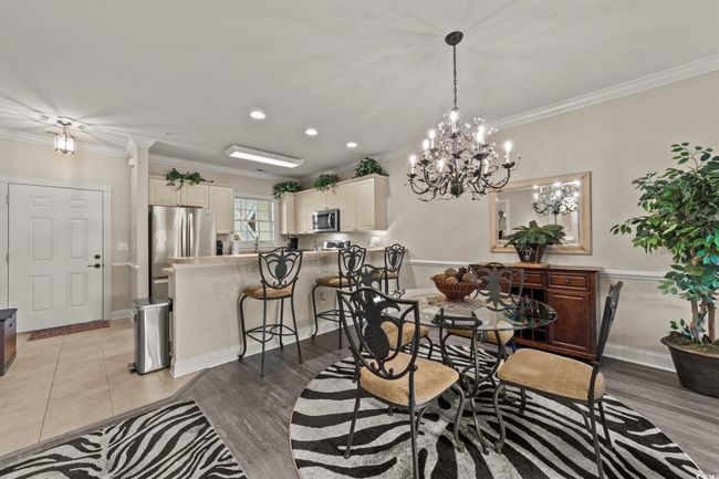Dining room with crown molding, a chandelier, recessed lighting, baseboards, and light wood finished floors | Image 6