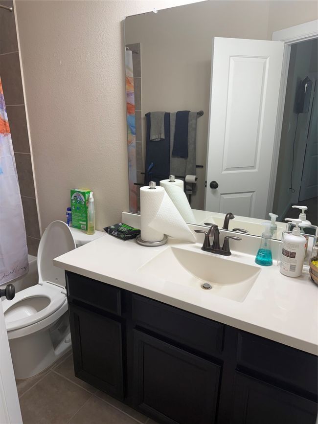 Bathroom featuring vanity, tile patterned flooring, and a shower with shower curtain | Image 6