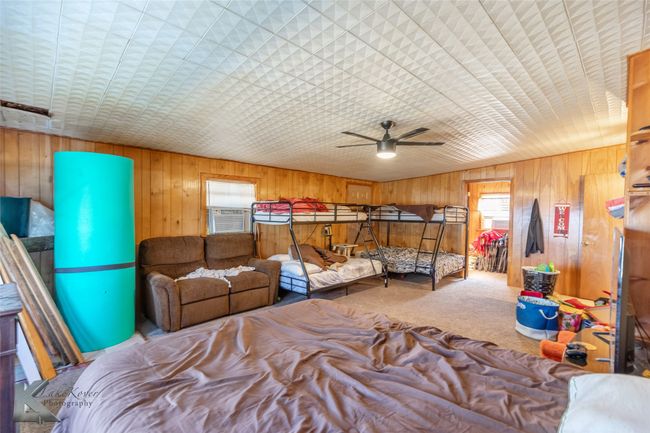 Carpeted bedroom featuring wooden walls and cooling unit | Image 25